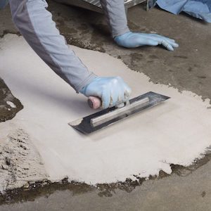 A two-component epoxy product premixed with selected graded aggregates to produces a high strength impermeable and chemically resistant mortar.